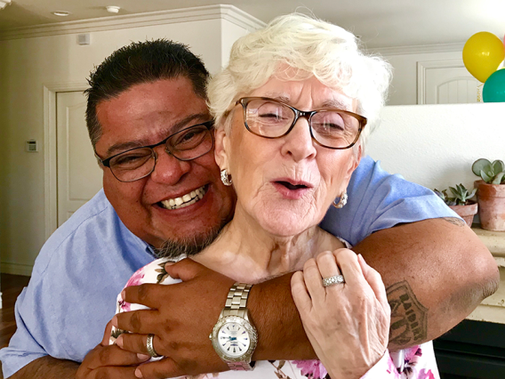 Man smiling and hugging his mother - Adult and eldercare support