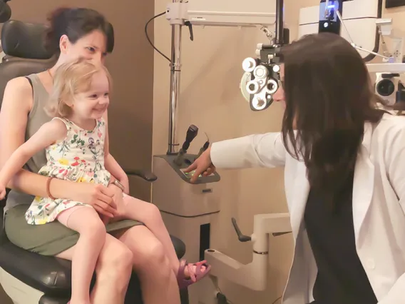 Mother, happy daughter, and doctor in a doctor's office