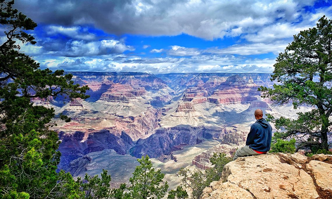 Man sitting at edge of Grand Canyon